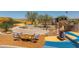 The outdoor playground offers a variety of structures, including a slide, climbing wall, and seesaw at 10308 S Bickwell Trl, Apache Junction, AZ 85120