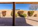 Covered patio with brick pavers and a view of the block fence and beautiful landscaping at 11258 E Ocaso Ave, Mesa, AZ 85212