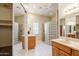 A bright bathroom featuring a glass block shower, double sinks, and updated fixtures for a spa-like experience at 11258 E Ocaso Ave, Mesa, AZ 85212