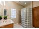 A relaxing bathroom features a glass block shower, modern vanity, and bright lighting, creating a clean space at 11258 E Ocaso Ave, Mesa, AZ 85212