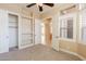 Bedroom with carpet, ceiling fan, closet with built-in shelving, and plantation shutters at 11258 E Ocaso Ave, Mesa, AZ 85212