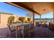 Comfortable covered patio featuring dining and lounge seating areas with brick pavers at 11258 E Ocaso Ave, Mesa, AZ 85212