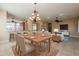 Open-concept dining area with chandelier adjacent to the kitchen and living spaces at 11258 E Ocaso Ave, Mesa, AZ 85212