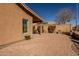 Backyard showcasing the desert landscape and a stone paver patio at 11258 E Ocaso Ave, Mesa, AZ 85212