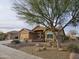 Beautiful home exterior featuring desert landscaping, mature trees, and a well-maintained facade at 11258 E Ocaso Ave, Mesa, AZ 85212