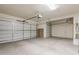 Spacious three-car garage with ample storage space, shelving, and overhead door openers at 11258 E Ocaso Ave, Mesa, AZ 85212