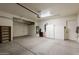 Clean and spacious garage featuring built-in shelving and a water heater at 11258 E Ocaso Ave, Mesa, AZ 85212