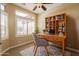 Bright home office with built in shelving, a large window, and neutral paint tones at 11258 E Ocaso Ave, Mesa, AZ 85212