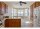 Bright kitchen nook with a full wall of shuttered windows and wood cabinets at 11258 E Ocaso Ave, Mesa, AZ 85212