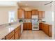 Well-appointed kitchen featuring granite countertops, wooden cabinetry, and modern appliances at 11258 E Ocaso Ave, Mesa, AZ 85212