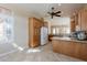 Bright kitchen featuring wood cabinets, granite countertops, and stainless-steel appliances at 11258 E Ocaso Ave, Mesa, AZ 85212