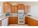 Bright kitchen with wooden cabinets, granite countertops, and modern white appliances at 11258 E Ocaso Ave, Mesa, AZ 85212