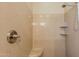 Close-up of the shower, featuring neutral stone-look walls, shelving and a modern shower head at 11258 E Ocaso Ave, Mesa, AZ 85212