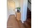 Light filled entryway featuring modern wood floors, small cabinet with mirror, and stairs to the upper level at 11300 N Casa Dega Dr # 1025, Surprise, AZ 85388