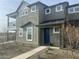 Inviting townhome featuring neutral stucco, white trim, a blue front door, and minimal landscaping at 11300 N Casa Dega Dr # 1025, Surprise, AZ 85388