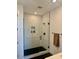 Modern bathroom with a glass enclosed tiled shower, recessed niche, and matte black hardware at 11300 N Casa Dega Dr # 1025, Surprise, AZ 85388