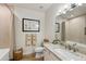 Relaxing bathroom with granite vanity, framed mirror, and tiled shower with patterned curtain at 11500 E Cochise Dr # 1090, Scottsdale, AZ 85259