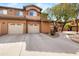 Exterior shot of the condo with two-car garages, showcasing curb appeal and desert landscaping at 11500 E Cochise Dr # 1090, Scottsdale, AZ 85259