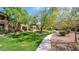 Well-manicured lawns and a paved walking path amidst lush greenery at 11500 E Cochise Dr # 1090, Scottsdale, AZ 85259