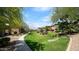 Lush green space with walking path, bushes, trees, and manicured lawn at 11500 E Cochise Dr # 1090, Scottsdale, AZ 85259