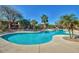 Resort-style swimming pool with ample deck space, palm trees and lounge chairs at 11500 E Cochise Dr # 1090, Scottsdale, AZ 85259