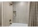 A luxurious shower with mosaic tile accents and integrated shelving is displayed at 11500 E Cochise Dr # 1090, Scottsdale, AZ 85259