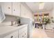 Bright laundry room featuring ample storage, a sink, and a modern washer and dryer at 122 E Loma Vista Dr, Tempe, AZ 85282