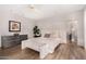 Well-lit bedroom boasting wood floors, neutral walls, bench seating, and modern furnishings at 122 E Loma Vista Dr, Tempe, AZ 85282