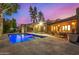 Stunning backyard pool with unique architectural details and lush landscaping at dusk at 122 E Loma Vista Dr, Tempe, AZ 85282