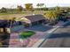 Aerial view of a home's exterior showing a well-maintained driveway and desert landscaping at 12426 W Cougar Dr, Sun City West, AZ 85375