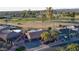 An aerial view of a well-maintained property with lush landscaping and a nearby golf course at 12426 W Cougar Dr, Sun City West, AZ 85375