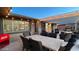 Entertaining patio area with dining table and chairs, plus outdoor refrigeration and pergola with string lights at 12426 W Cougar Dr, Sun City West, AZ 85375