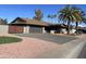 A well-maintained house featuring a gray garage door, paver driveway, and desert landscaping at 12426 W Cougar Dr, Sun City West, AZ 85375