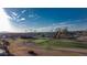 Panoramic view of a beautiful golf course featuring well-maintained greens, mature trees, and blue skies at 12426 W Cougar Dr, Sun City West, AZ 85375