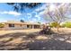 Large backyard featuring desert landscaping, covered patio, and shade structure at 12630 W Crystal Lake Dr, Sun City West, AZ 85375