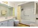 Bright bathroom featuring a tub with shower and a large mirror over the vanity at 12630 W Crystal Lake Dr, Sun City West, AZ 85375