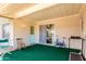 Enclosed sun room with green carpet and a sliding door that leads to the backyard at 12630 W Crystal Lake Dr, Sun City West, AZ 85375