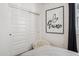 Cozy bedroom corner with a 'Je t'aime' art piece above a furry chair and a sliding door closet at 1325 S 239Th Dr, Buckeye, AZ 85326