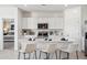 Bright kitchen with white cabinets, a central island, and modern fixtures at 1325 S 239Th Dr, Buckeye, AZ 85326