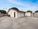 Rear view of the home featuring driveway, neutral paint and attached garage at 1329 N 25Th St, Mesa, AZ 85213