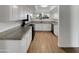 Well-lit kitchen with granite countertops, stainless steel appliances, and light wood-look flooring at 1329 N 25Th St, Mesa, AZ 85213