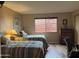 Comfortable bedroom featuring two twin beds, hardwood floors and a window at 13808 N 108Th Dr, Sun City, AZ 85351