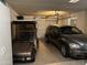 Two-car garage with car, golf cart, and bright overhead lighting at 13808 N 108Th Dr, Sun City, AZ 85351