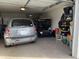 Two-car garage with car, golf cart, and additional storage at 13808 N 108Th Dr, Sun City, AZ 85351