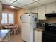 Well-lit kitchen featuring white cabinets, breakfast nook, and tile flooring at 13808 N 108Th Dr, Sun City, AZ 85351