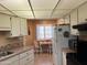 Bright kitchen with white cabinets, breakfast nook, and ample counter space at 13808 N 108Th Dr, Sun City, AZ 85351