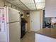 Practical kitchen featuring white cabinets, tile flooring, and modern appliances at 13808 N 108Th Dr, Sun City, AZ 85351