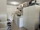 Well-organized laundry room with washer, dryer, storage cabinets, and convenient shelving for supplies and storage of appliances at 13808 N 108Th Dr, Sun City, AZ 85351