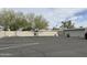 Empty parking lot with mature trees and parking spots at 13808 N 108Th Dr, Sun City, AZ 85351