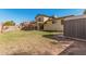 Backyard with large grassy area, partial fence, balcony, and outdoor shed at 1438 S 30Th St, Mesa, AZ 85204